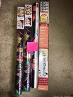 Four of the sealed window film rolls standing upright showing packaging and patterns