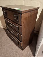 Three-quarter view of dresser showing four drawers and side panel condition