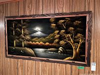 full view of framed black velvet mountain landscape painting on wall
