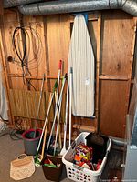 Overall lot showing ironing board, cleaning tools, bucket, laundry basket