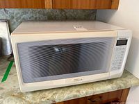 Front view of Panasonic NN-S543WB microwave showing window and overall condition