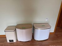 Three hamper bins side by side showing size and shape comparison