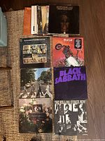 Overview of eight LP album covers laid out on floor