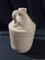 Full view of jug showing handle, spout, blue stripes