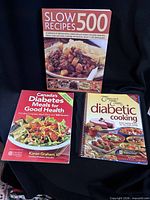 Front covers of the three cookbooks displayed