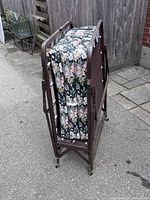 Folded rollaway bed showing metal frame and casters