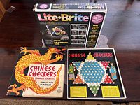 Lite-Brite box, Chinese Checkers box and board displayed together