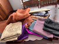 Pile of assorted fabric pieces on table