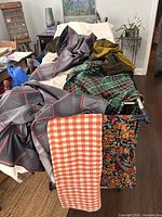 Mixed fabrics draped over table showing colors and patterns