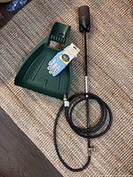 Torch burner, hose, gloves and leaf scoop overview