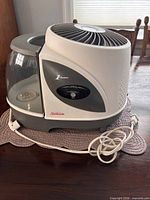Front and side view of Sunbeam SCM7809 humidifier with power cord and water tank attached