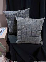 Both cushions displayed upright to show size and patterns