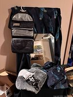 Mirror, toiletry bag, shower curtain, rug and hair dryer grouped