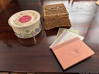 Basket, tin, three books on table
