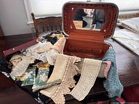 Open travel case filled with assorted lace and trims on table