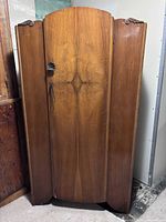 Front view of wooden wardrobe showing single door and grain pattern