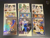 Full group shot of all 12 Zach Wilson rookie cards in sleeves