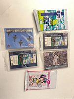 All six sealed trading-card packs laid out