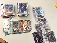 Stacks of Panini basketball trading cards showing variety and sleeved protection