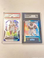 Front view of both graded football cards in slabs side-by-side