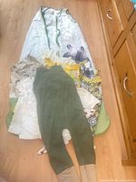 Overview of all seven clothing pieces laid out on floor