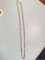 full view of gold-tone chain laid out