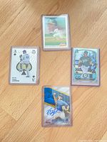 Four sleeved cards including Brent Honeywell Jr. autograph, Jacob deGrom Mosaic Ace, Athletics Topps base, Bowman 1st Prospect