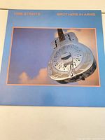 Front album cover showing resonator guitar image