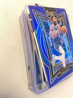 Stack of sleeved Dallas Mavericks cards showing top Kyrie Irving Select blue parallel