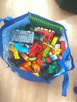 Bag filled with assorted Duplo-size blocks and parts