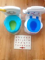 Two potty chairs and alphabet board overview
