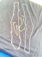 All four beaded jewellery pieces laid out on dark cloth