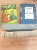 All four books front spines and covers visible