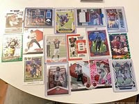 Group shot of 15 assorted NFL cards on tabletop