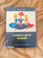 Front of book with dust jacket showing title and illustration