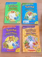 All four Pokémon Super Special Flip Books front covers visible
