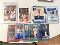 Group shot of roughly 15 NBA trading cards including relic, parallels and vintage bases