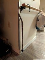 Full view of cane leaning against wall showing overall shape and pattern