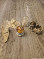 All four angel-themed decor items on floor