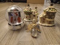 Group shot: two ceramic houses, snow globe, glass angel ornament