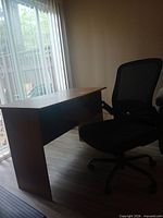 Desk and chair together in room