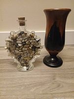 Glass vase bottle and wooden vase side by side