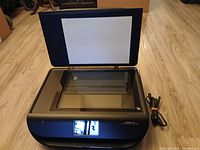 Printer lid open showing flatbed scanner glass