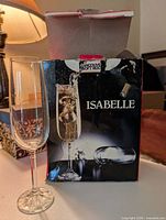 Single flute displayed beside Isabelle branded box