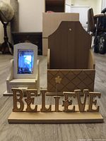 Front view showing BELIEVE sign, mirror with drawer, and desk organizer