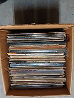Box filled with stacked 12" vinyl LPs viewed from top