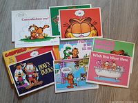 Seven Garfield humour postcards laid out showing fronts