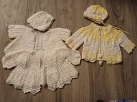 Crocheted layette sets white and yellow items