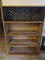 Front view showing entire bookcase with star-patterned liner and shelves