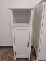 Front view of narrow single-door white cabinet